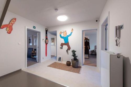 a man jumping in the air in a living room at Chez RG in Bruges