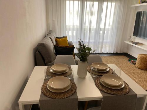 a living room with a table with plates on it at Sobrecueva Paraiso I in Cangas de Onís