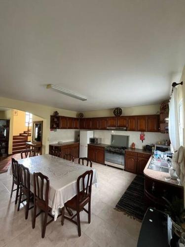 a kitchen with a table and chairs in a room at Mountain retreat in Boaventura