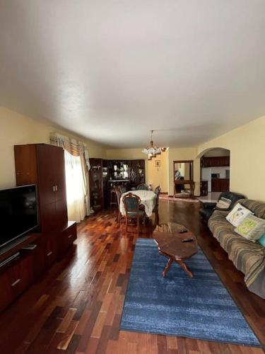 a living room with a couch and a table at Mountain retreat in Boaventura