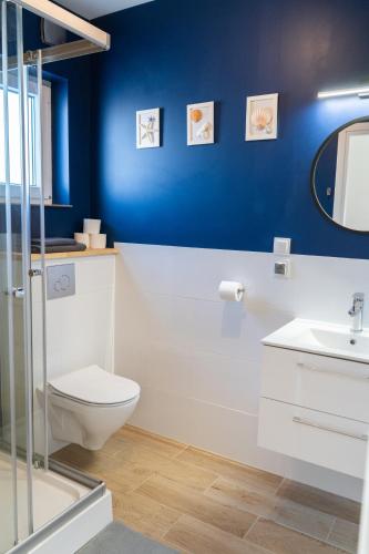 a bathroom with a toilet and a sink at Domki Przystań Kotwica in Jastrzębia Góra
