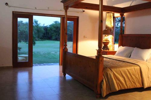 a bedroom with a bed and a view of a golf course at JuanDolio Guavaberry +3Brd 13p/p in Juan Dolio