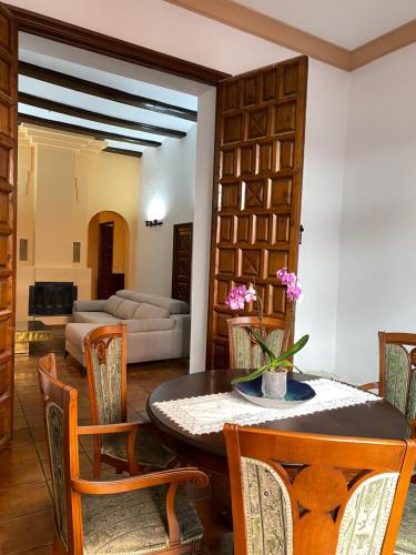 a living room with a table and chairs at Garden Suites Xativa in Xàtiva