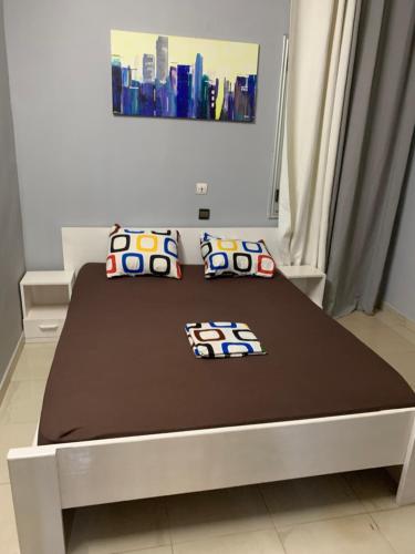 a bed with two pillows on it in a room at Villa JFK2 in Ouagadougou