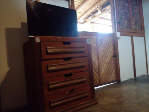 a dresser with a flat screen tv on top of it at La Casa de Diego in Zorritos