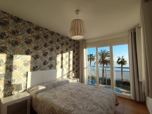 a bedroom with a bed and a view of the ocean at Apartamento Azul Marino in Denia