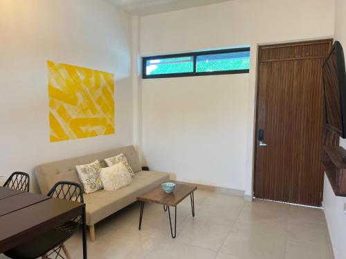 a living room with a couch and a table at Departamentos Plaza 32 in Mérida