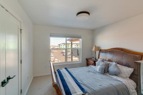 a bedroom with a bed with a view of a beach at Modern Bozeman Condo with Balcony and Mountain Views! in Bozeman
