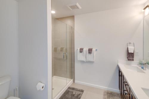a bathroom with a shower and a toilet and a sink at Modern Bozeman Condo with Balcony and Mountain Views! in Bozeman