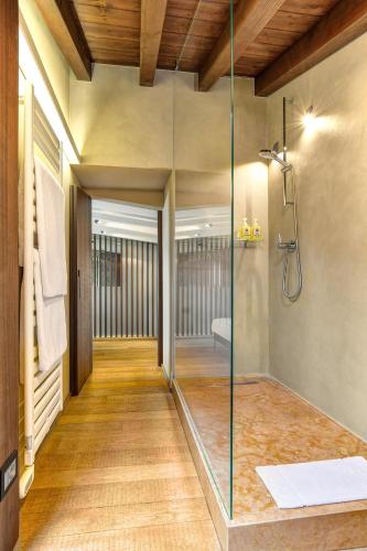 a glass shower in a bathroom with a walk in shower at 5 Terrazze Exlusive Apartments in Gargnano
