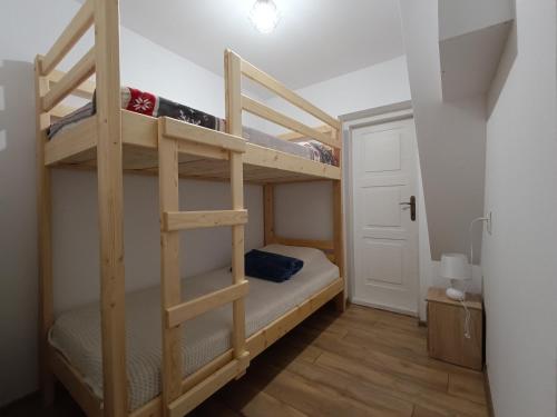 a bedroom with two bunk beds in a room at Dom na Smyrakach in Zawoja