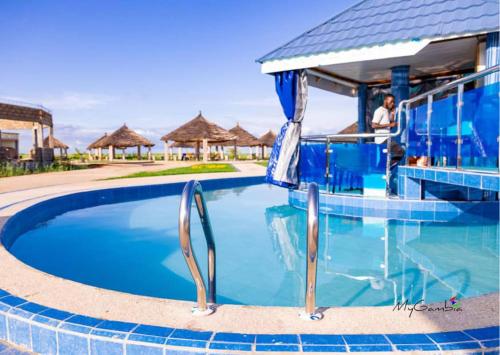 a swimming pool at a resort with a resort at Beautiful Seaview Superior Room in Bakau in Bakau