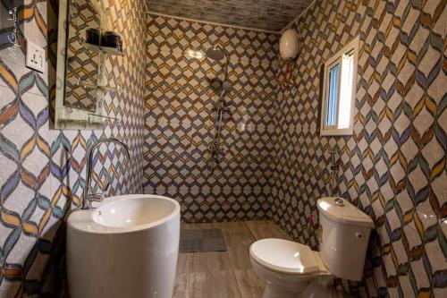 a bathroom with a toilet and a sink and a shower at Beautiful Seaview Superior Room in Bakau in Bakau