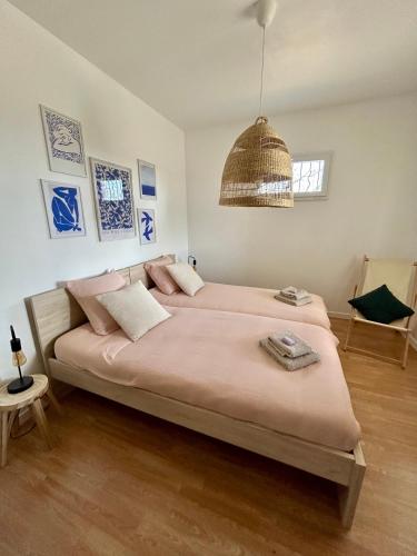 - une chambre avec un grand lit et un pendentif dans l'établissement Villa Augustine, nature & vue panoramique, à Berrias Et Casteljau