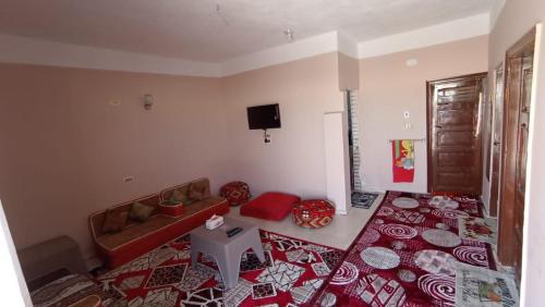 a living room with a bed and a couch at Nubian Bayt Ward in Siwa in Siwa