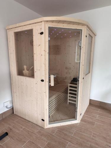 a wooden room with a glass door in a room at Podere il Glicine Wellness Charme & Relax in Fresonara