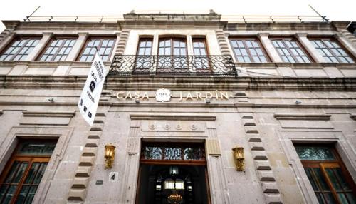 a building with a sign on the front of it at Hotel Boutique Casa del Jardín Aguascalientes in Aguascalientes