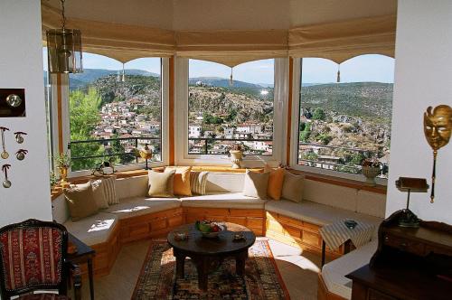 a living room with a couch and a large window at Villa Captain's View in Néa Epídhavros