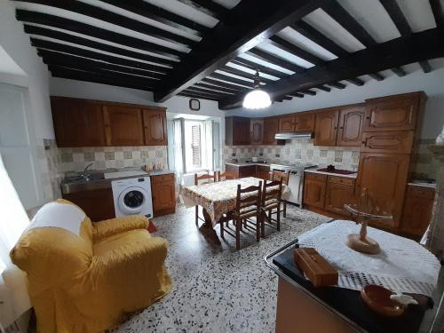 a kitchen with a couch and a table in it at Appartamento ai Domenichetti in Barga