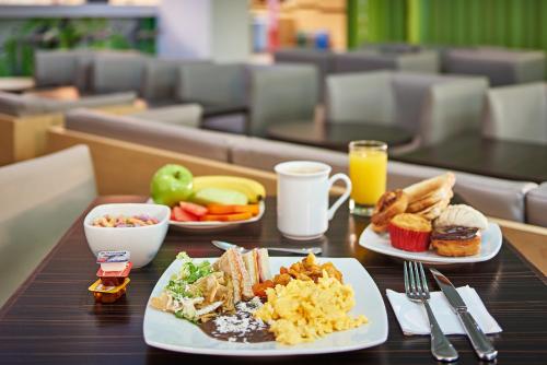 two plates of breakfast food on a table at Ibis Cancun Centro in Cancún