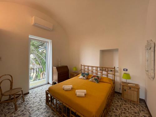 a bedroom with a bed and a large window at La Cuchina in Capri
