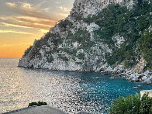 a view of the ocean with a rocky mountain at La Cuchina in Capri