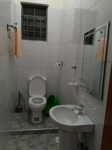 a bathroom with a toilet and a sink at Kasha's Hideout 1 Namugongo Sonde in Mukono