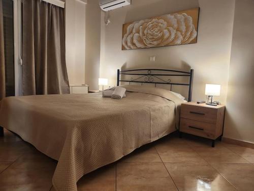 a bedroom with a bed and two lamps on a night stand at 'Elia gytheio in Mavrovouni