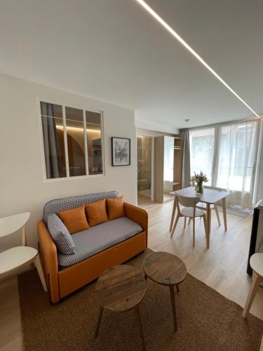 a living room with a couch and a table at Maison Meire Studios in Cognac