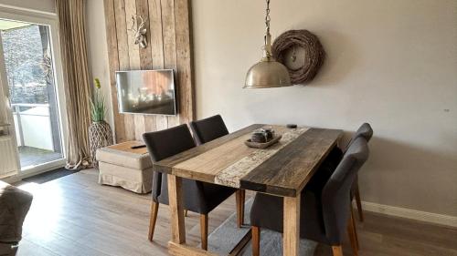 a dining room with a wooden table and chairs at ferienapartment hahnenklee Apart 1 in Hahnenklee-Bockswiese