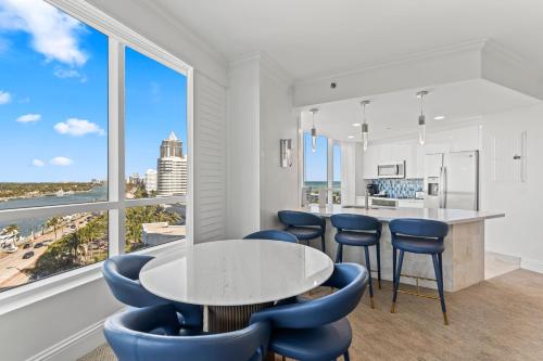 a kitchen with a table and chairs and windows at Luxury King apartment with Bay View at Miami Beach in Miami Beach