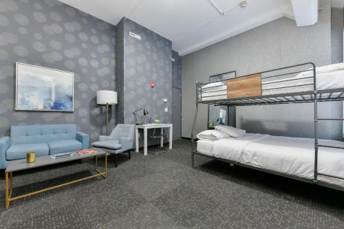 a bedroom with a bunk bed and a chair at Temple Place Suites 2+3 in Boston