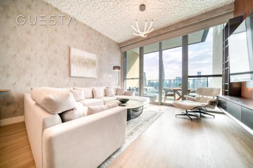 a living room with a white couch and a table at Downtown Views I - Burj Khalifa View, Downtown Dubai in Dubai