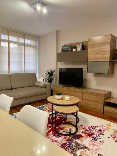 a living room with a couch and a table at Piso Vistas O Son in Cee