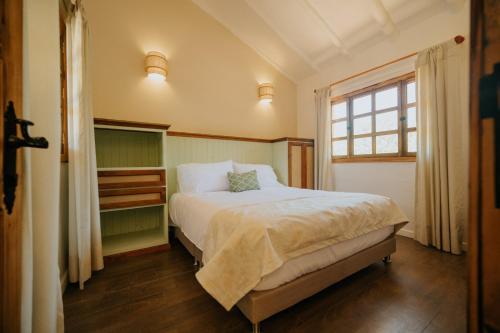 a bedroom with a large bed with a window at Hotel La Corada in Villa de Leyva
