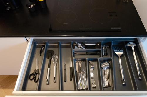 a tray filled with utensils in a drawer at Pacific Residences - Studio in Antwerp