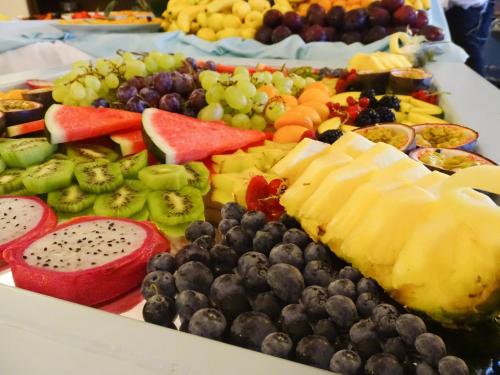 a tray of fruits and vegetables on a table at Hotel Monte Turri - Adults Only in Àrbatax