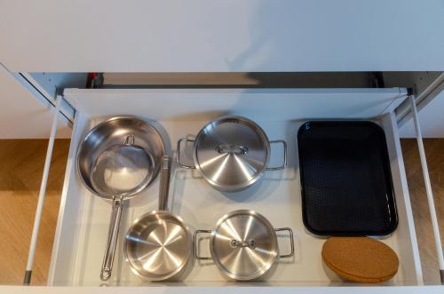 a group of straining utensils in a kitchen at Pacific Residences - Studio in Antwerp