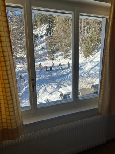 a window with a view of a snow covered field at Sorecrans in Crans-Montana