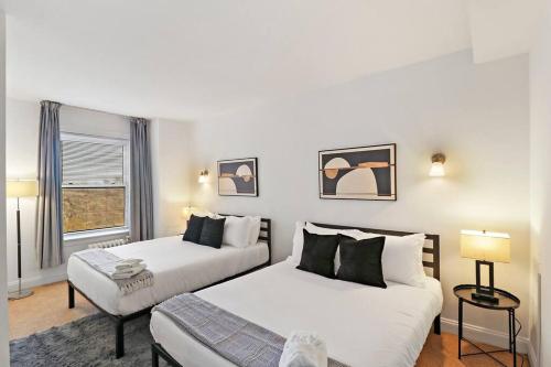 a bedroom with two beds and a window at Sleek 1-Bedroom Apt in Chicago - East Park Tower 0610 rep in Chicago
