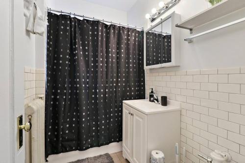 een badkamer met een zwart douchegordijn en een toilet bij Sleek 1BR Chicago Hideaway - East Park Tower 0610 rep in Chicago