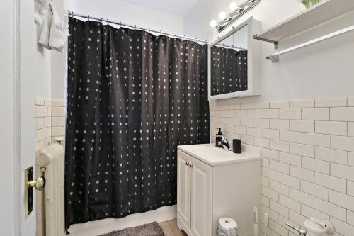 a bathroom with a black shower curtain and a toilet at Sleek 1-Bedroom Apt in Chicago - East Park Tower 0610 rep in Chicago