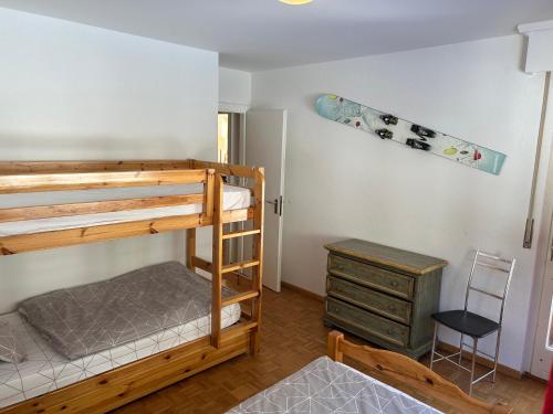 a bedroom with bunk beds and a skateboard on the wall at Sorecrans in Crans-Montana