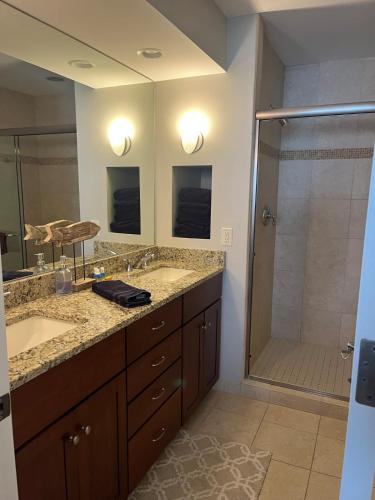 a bathroom with two sinks and a shower at Beautiful views from Fifth Floor Suite in Traverse City