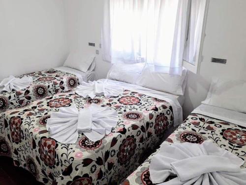two beds sitting next to each other in a room at Almirante Brown 49 in Mar de Ajó