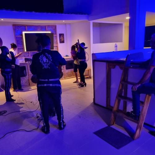 a group of people standing around a bar in a room at Dreimar Hotel Boutique in Cartagena de Indias