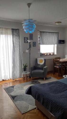 a bedroom with a bed and a chair and a table at Barbara in Bjelovar