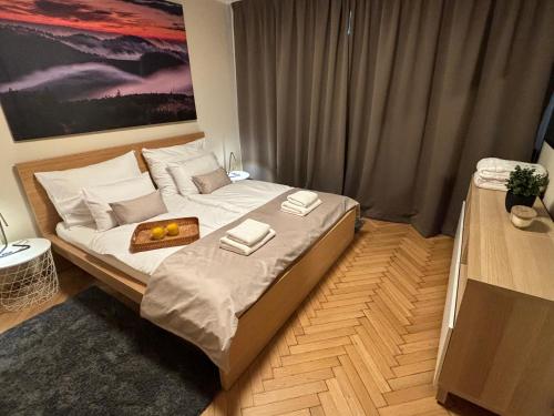 a bedroom with a bed with a tray of food on it at Apartman Relax in Zvolen