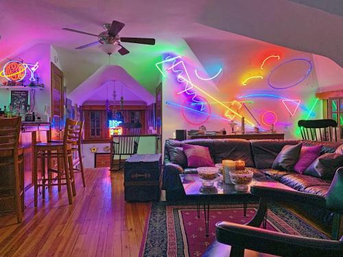 a living room with neon lights on the wall at Mike & Allen's Place on the Park_1 in Columbus