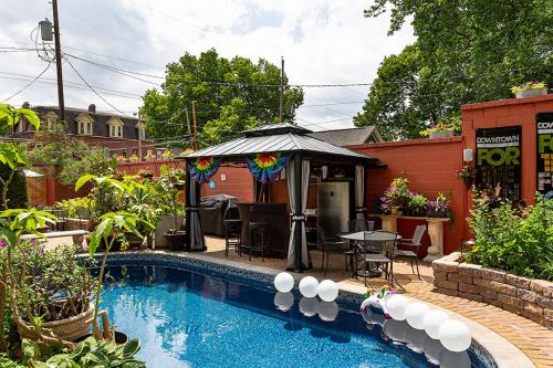 a swimming pool with an umbrella next to a house at Mike & Allen's Place on the Park_1 in Columbus
